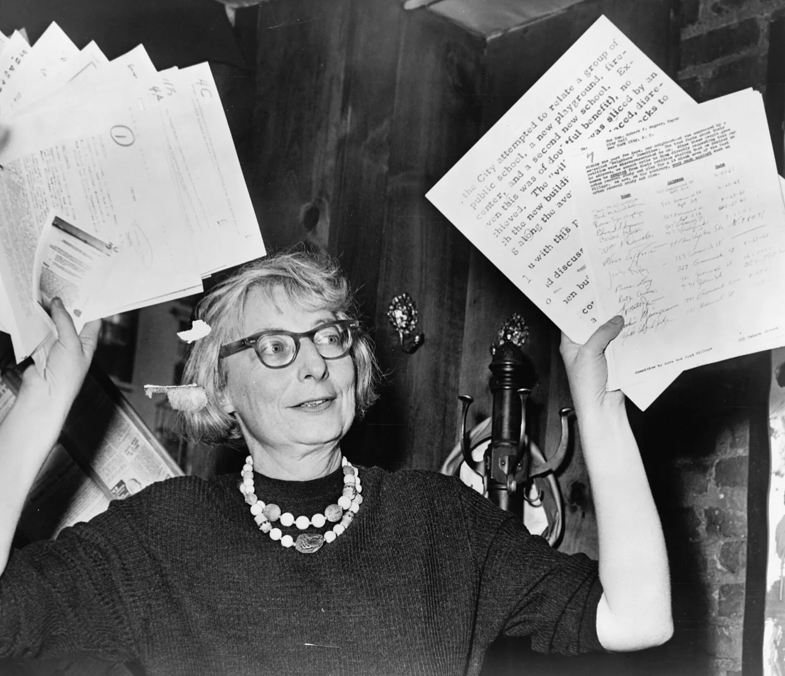 Jane Jacobs holds up documentary evidence at a 1961 West Village press conference